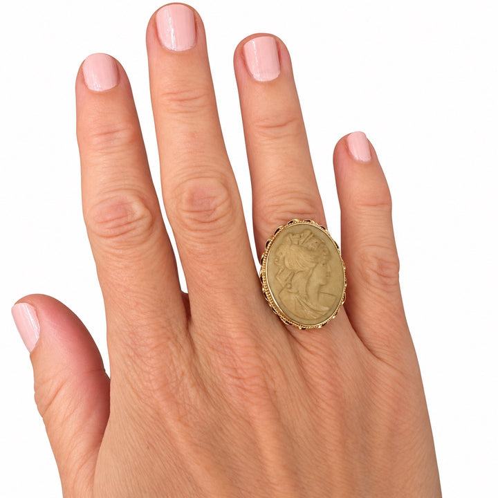 14K yellow gold lava stone cameo ring shown on hand for scale