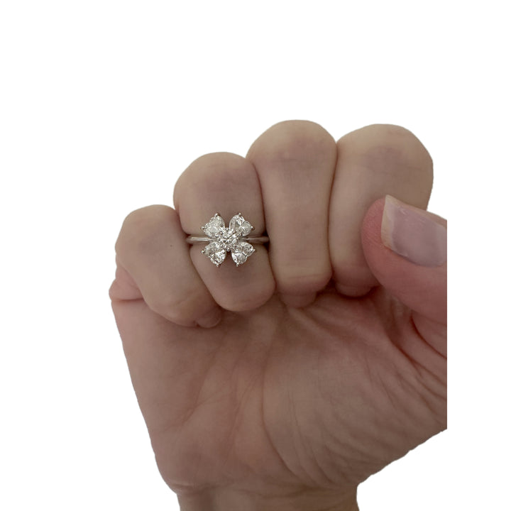 Platinum diamond clover ring worn on a hand