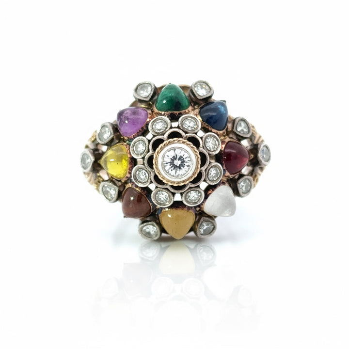 Multicolored gemstone ring with a central diamond on a white background