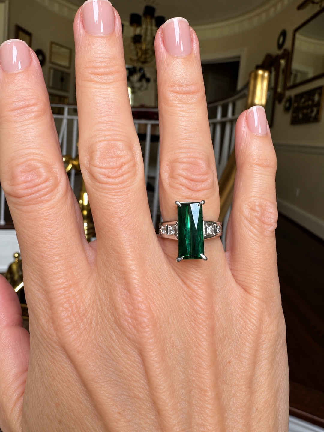 Estate green tourmaline and diamond ring in platinum on hand